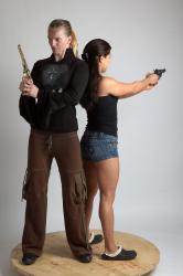OXANA AND XENIA STANDING POSE WITH GUNS